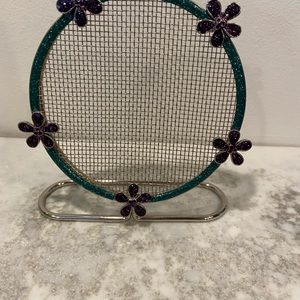 Earring holder. Solid design with sparkling enamelled flowers green and purple.